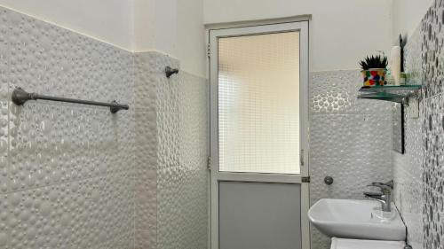 a bathroom with a shower and a sink and a toilet at Vacation Beach in Hikkaduwa