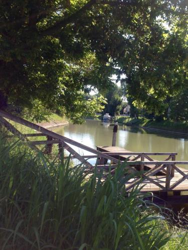 a wooden bridge over a river in a park at The Riverside Suite in Mira