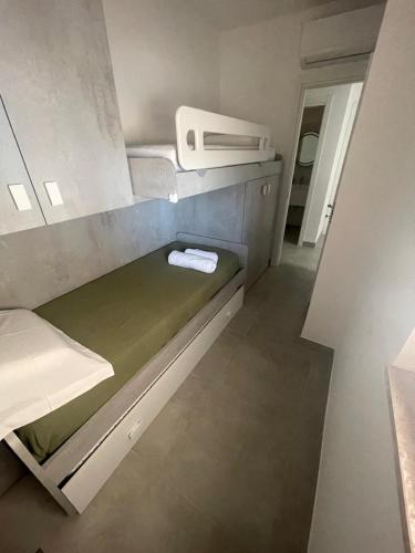 a small room with two bunk beds in it at Brezza Marina - Vacation Condo in Marina di Vasto