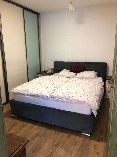 a bedroom with a large bed with two pillows on it at Budha house in Lošonec