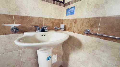 a bathroom with a sink and a shower at Hotel estación Kristal - Corferias in Bogotá