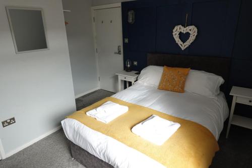 a bedroom with a bed with a blanket on it at The Southport Seaside Snug Suites in Southport