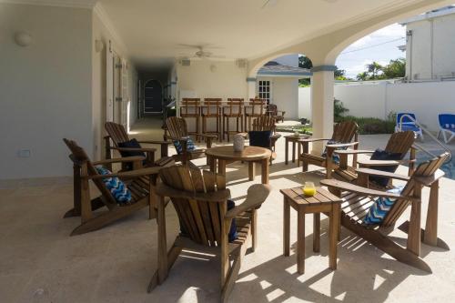 a group of tables and chairs in a patio at Sandgate in Bridgetown