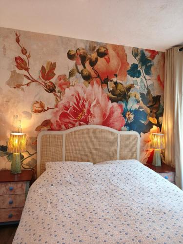 a bedroom with a flower mural on the wall at Cheltenham town centre with parking space in Cheltenham