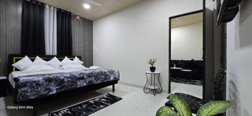 a bedroom with a bed and a large mirror at Lavish Abode black & white in Guwahati
