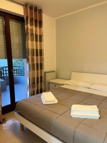 a bedroom with a bed with two towels on it at Casa Ponte in Ponte San Giovanni