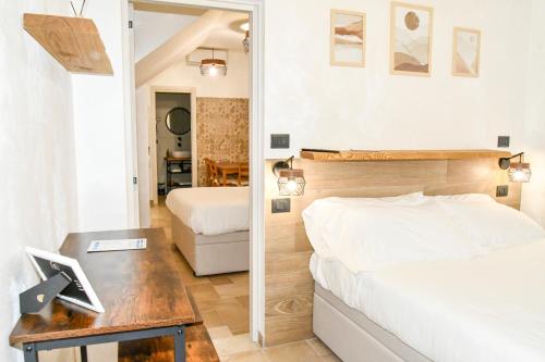 a bedroom with a bed and a desk with a mirror at Hasu Rental Rooms in Trani