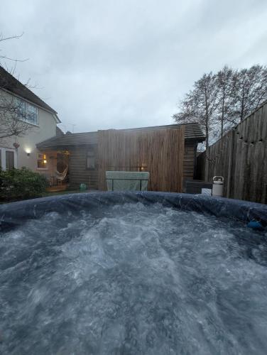 a hot tub filled with snow in a backyard at Stylish central Horsham residence with parking and hot tub in Horsham