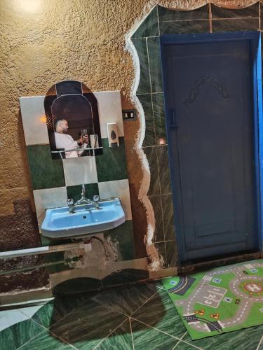 a bathroom with a picture of a sink at Miral Nubian House in Aswan