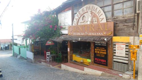 a building with a sign for a restaurant at Pousada da Pipa in Pipa