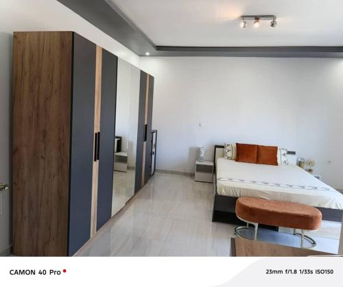 a bedroom with a bed and a sliding door at Serenity in Dakan