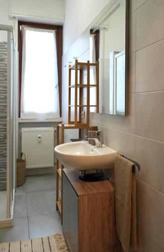 a bathroom with a sink and a mirror at UNIque Apt Bergamo 2 in Bergamo
