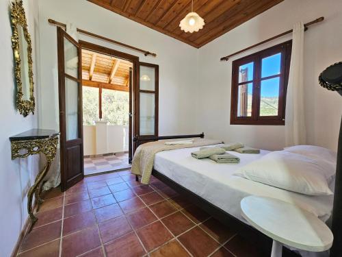 a bedroom with a large bed and a window at Lemon Nest in Marathokampos