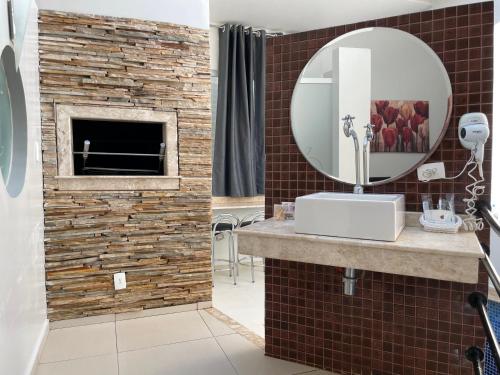 a bathroom with a sink and a mirror at Motel Sedución (Adults only) in Cascavel