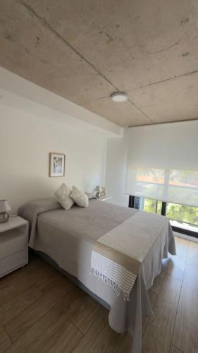 a bedroom with a bed and a large window at Sea Side2 in Piriápolis