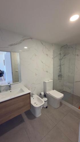 a bathroom with a sink and a toilet and a shower at Sea Side2 in Piriápolis
