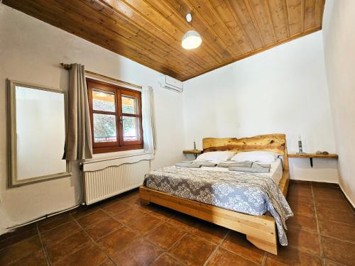 a bedroom with a bed and a window at Orange Nest in Marathokampos