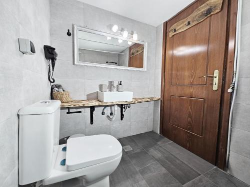 a bathroom with a toilet and a sink at Orange Nest in Marathokampos