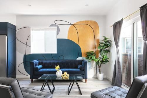 a living room with a blue couch and a table at Central LA Escape Near Universal & Beaches in Los Angeles