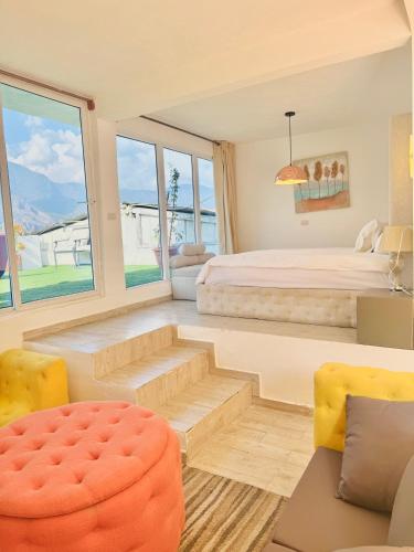 a bedroom with a bed and a large window at DUBAI by luxury Atitlan in San Pedro La Laguna