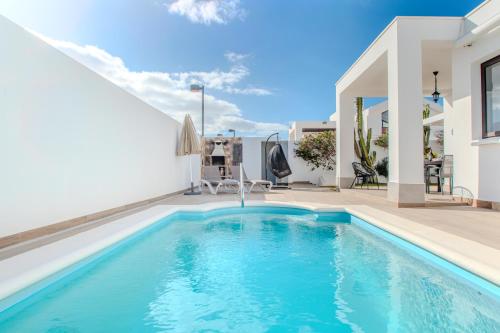 a swimming pool in the backyard of a house at Casa Maurizio - Heated Pool, Hot Tub & Hammam in Playa Blanca