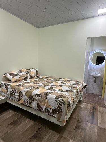 a bedroom with a large bed and a sink at Hotel ANY in Los Córdobas