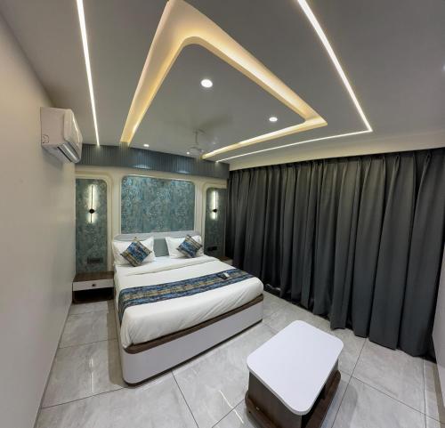 a bedroom with two beds and a large window at Hotel Vallabh Sky in Goya Gate
