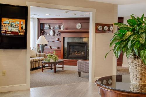 a living room with a fireplace and a couch at Ramada by Wyndham Boston in Boston