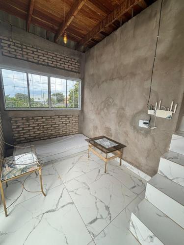 a room with a marble floor and a table at Chalé Florada d' Serra in Chapada dos Guimarães