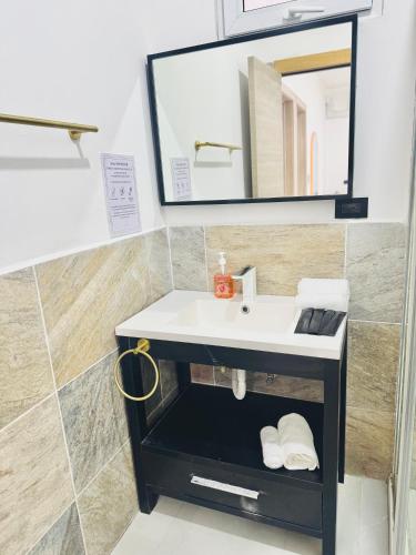 a bathroom with a sink and a mirror at LA VILLA by luxury Attilan in San Pedro La Laguna