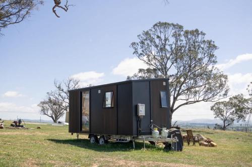 a tiny house on a trailer in a field at Beckford Tiny House 2 by Tiny Away in Good Hope
