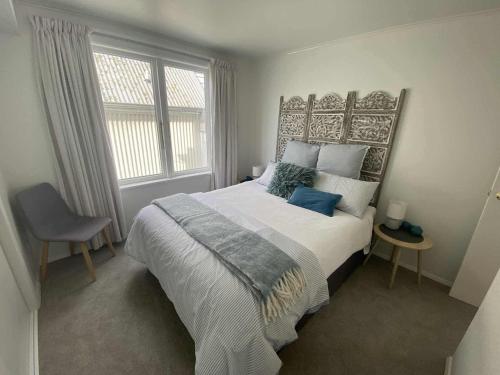 a bedroom with a large bed and a window at Nelson Harbour View in Nelson