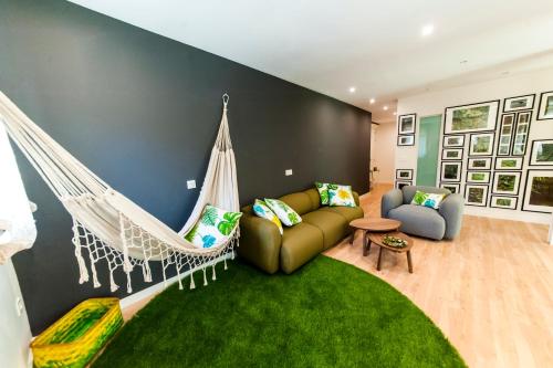 a room with a hammock and a couch at El Mirador Del Alcazar in Segovia