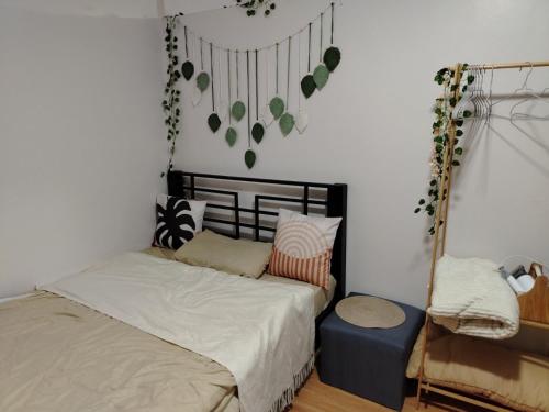 a small bedroom with a bed and a chair at Casita Bonita in Marilao