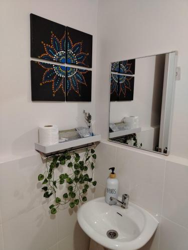 a bathroom with a sink and a mirror at Casita Bonita in Marilao