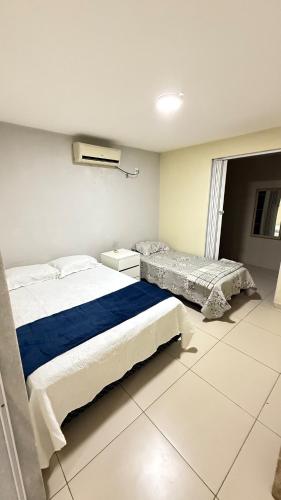 a bedroom with two beds and a window at Comfortable house in Natal in Natal