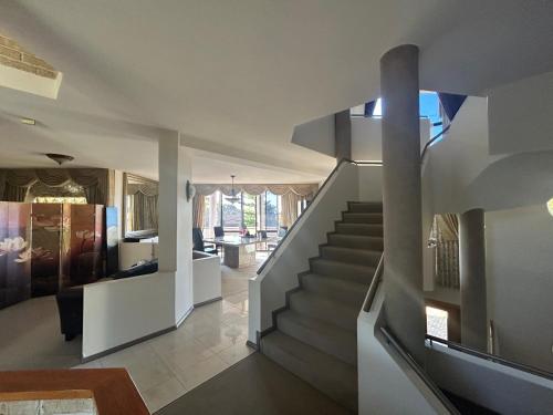 a staircase in a house with a living room at Comfort Home For You 203 in Perth