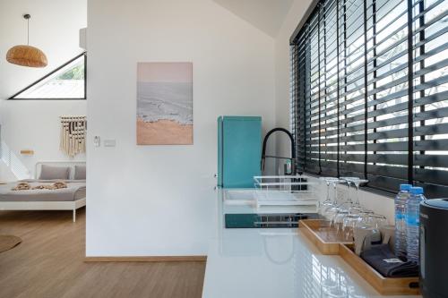 a bathroom with a sink and a large window at The Cosy Sunset Beach Resort in Thong Sala