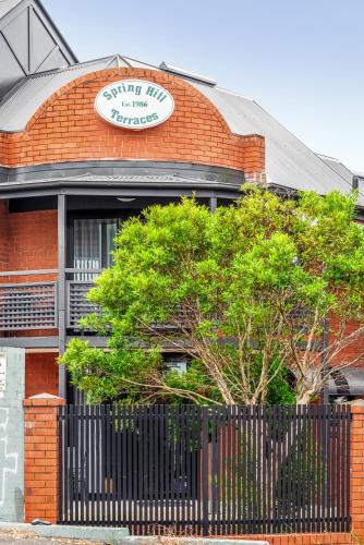 a red brick building with a sign on it at Spring Hill Inn in Brisbane