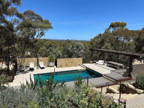 a swimming pool in the middle of a yard at HeartStone Hill by Tiny Away in Castlemaine