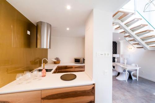a kitchen with a white counter top and a staircase at El Mirador Del Alcazar in Segovia
