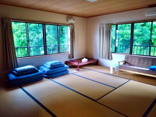 a living room with a couch and pillows on the floor at 大砂荘 OZUNA CAMP and LODGE in Kaiyo