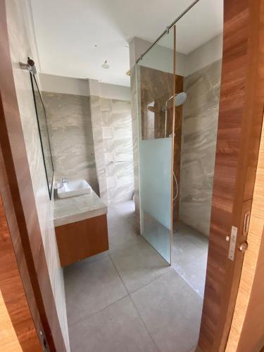 a bathroom with a shower and a sink at Green Minimalist in Jakarta