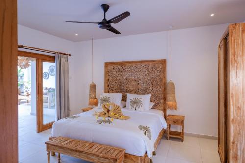 a bedroom with a bed and a ceiling fan at Villa Jati Private Pool - Amed in Amed
