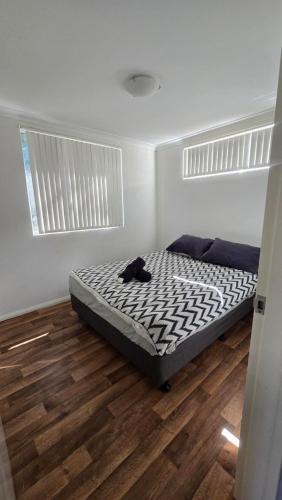 a bedroom with a bed with a black cat laying on it at Four Seasons Holiday Park in Marybrook