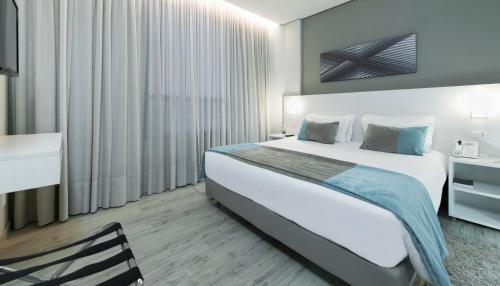 En eller flere senger på et rom på Comfort Hotel & Suítes Rondonópolis