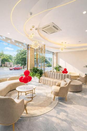 a lobby with couches and chairs and a table at HAO LAN LUXURY Hotel in Bắc Quang
