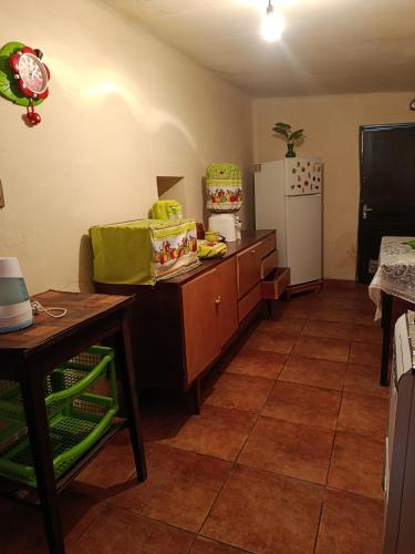 a kitchen with a counter and a refrigerator at Casa Magnolia in Cochabamba