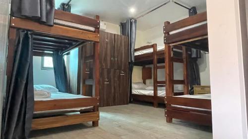 a room with three bunk beds and a mirror at Catba Chilling House Pool & Bar in Cat Ba