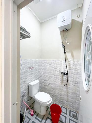 a bathroom with a toilet and a shower at SYARIAH - 3BR Homeyy by Sakura in Krawang